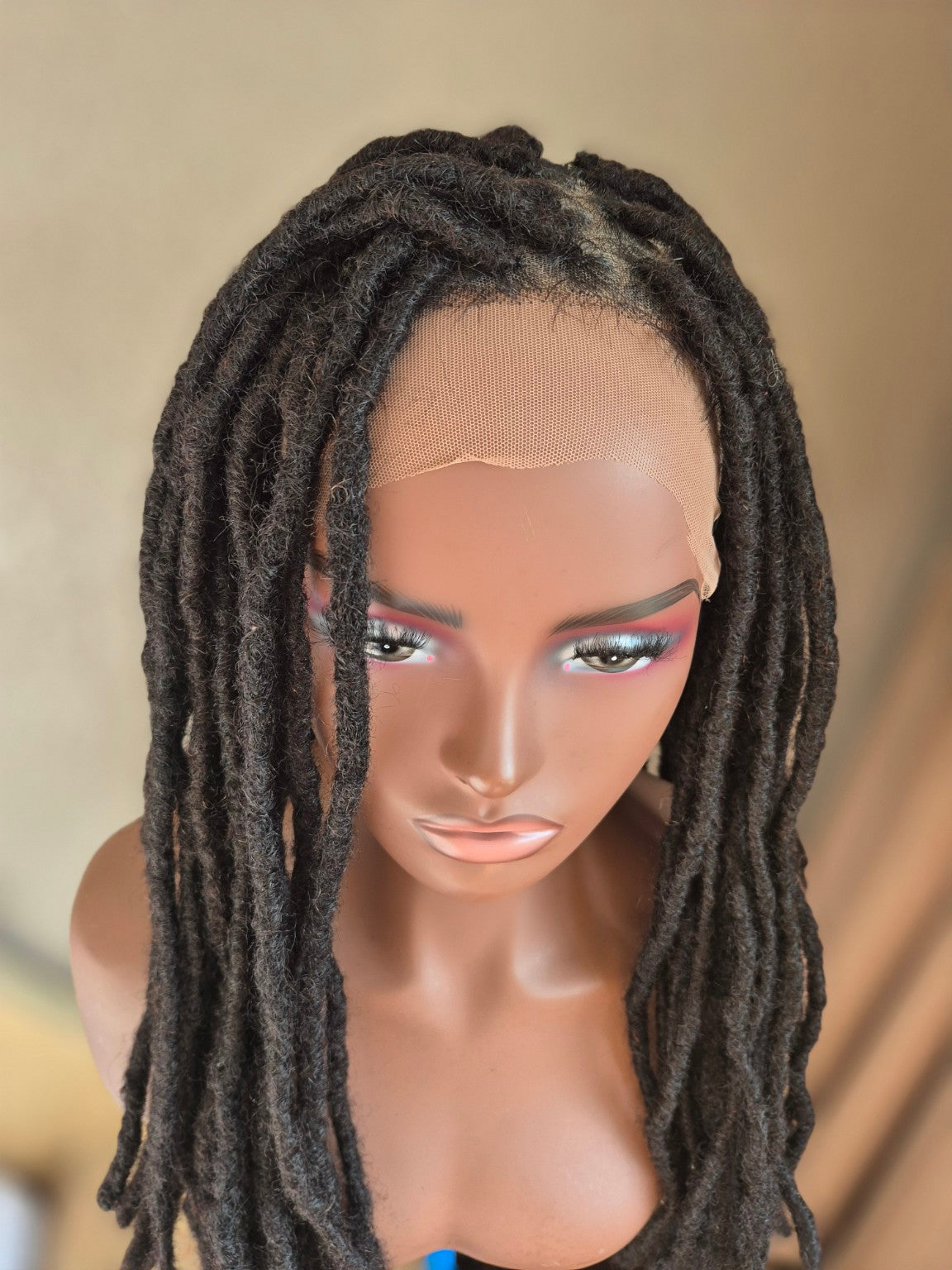 Long dark loc Crown closeup of lace front construction