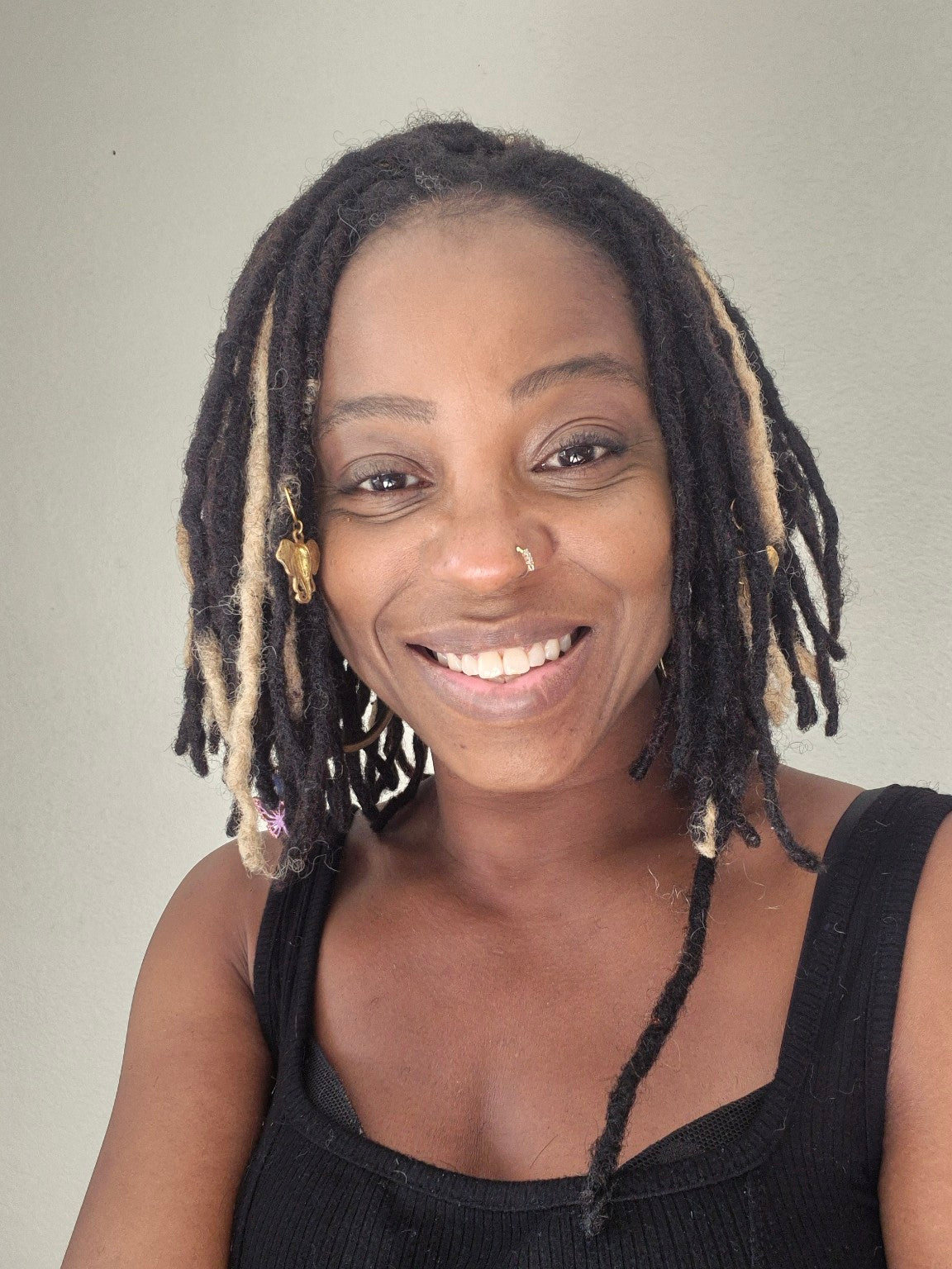 Real-life wearing example showing preserved black and blonde locs in a short style