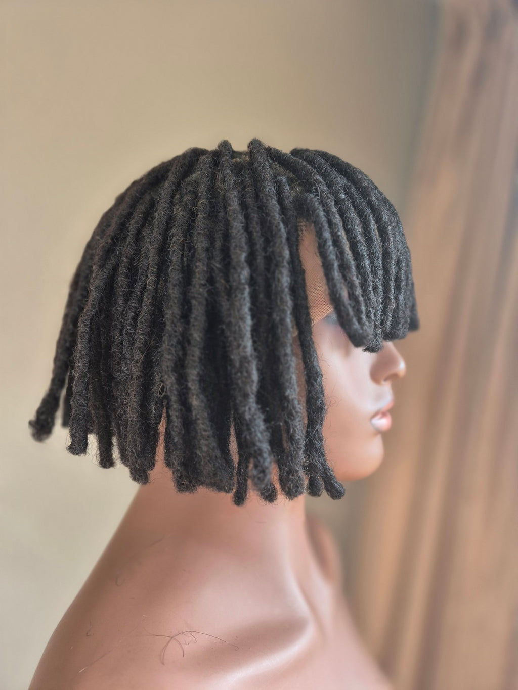 Side profile of short black loc bob